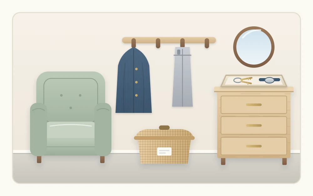 An empty armchair beside a wall row of four hooks holding two garments, a small lidded basket on the floor and a tray with keys and a watch