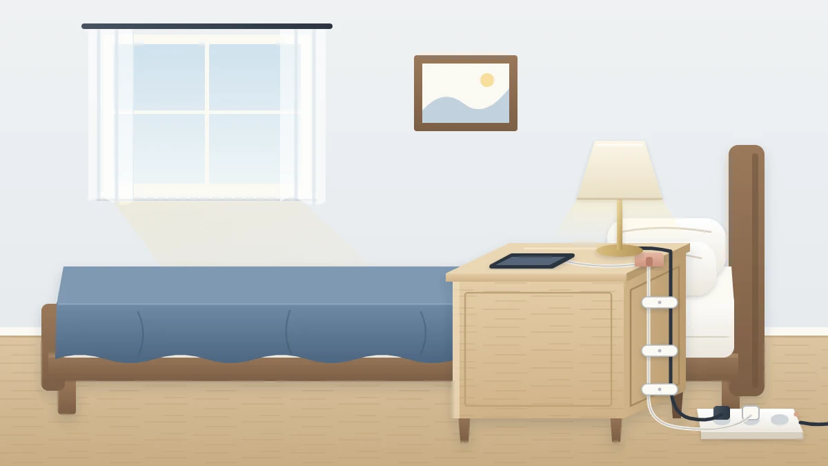 Back view of a wooden nightstand with two cords clipped neatly down its rear edge, a lamp on top and a phone cable in a small holder