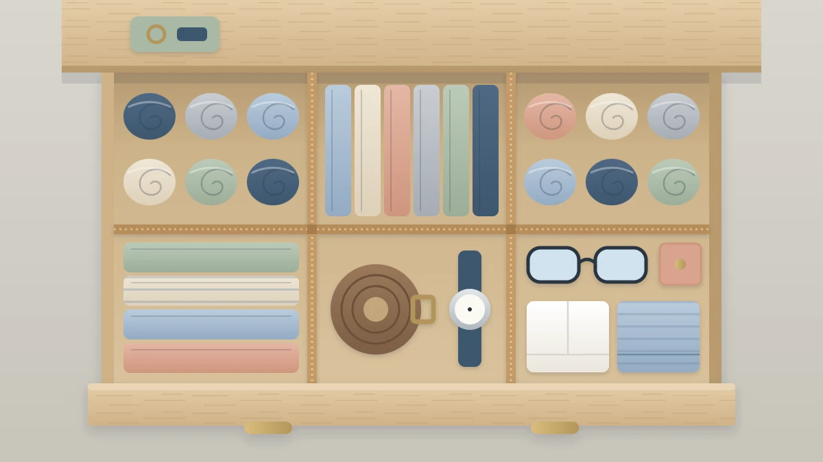 Open dresser drawer from above with a handmade cardboard grid of six compartments holding rolled socks, folded underwear and accessories