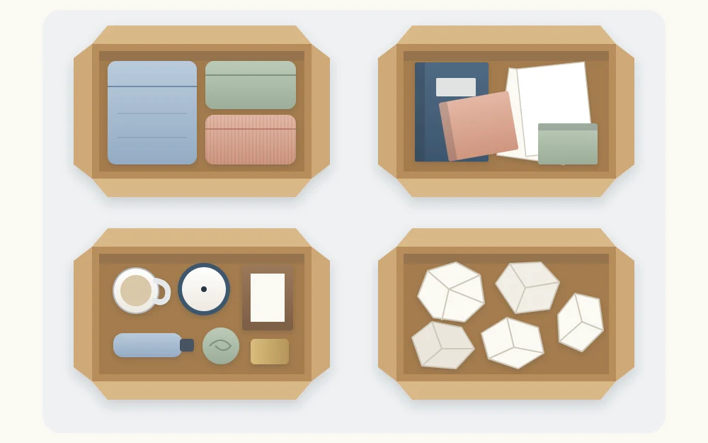 Four open boxes seen from above arranged in a square, holding folded clothes, books and papers, small household objects and crumpled paper