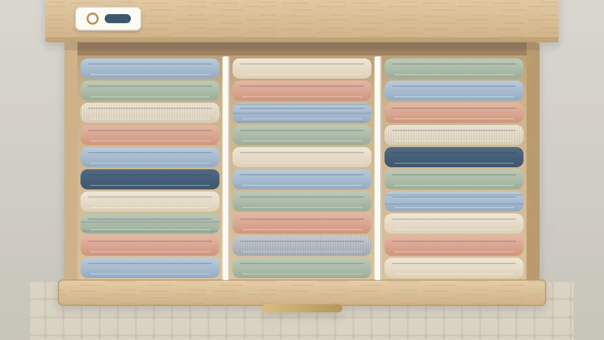 Top view of an open drawer filled with T-shirts folded into upright rectangles in a row, every shirt edge visible