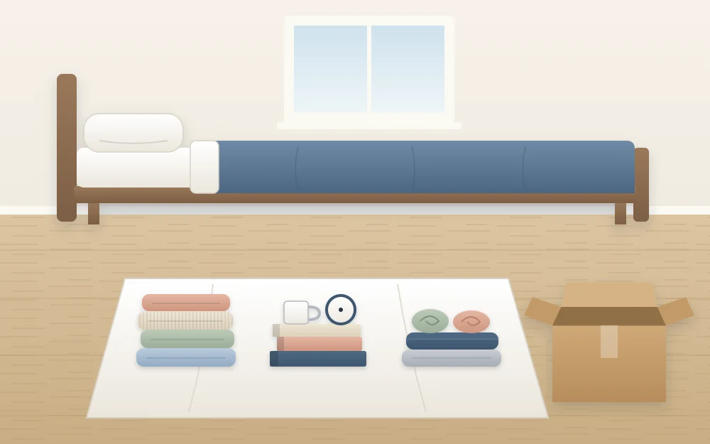 A bedroom floor with three separate sorting piles of folded clothes and objects on a sheet, an empty box beside them
