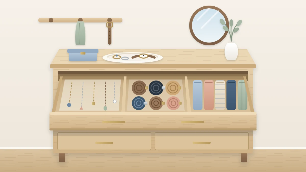 A dresser top with a small dish of rings and a watch, and an open drawer with a divided tray of necklaces, rolled belts and folded scarves