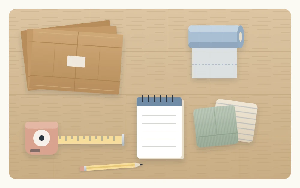Kit seen from above: three flattened cardboard boxes, a roll of bags, two folded cloths, a tape measure, a notepad and a pencil
